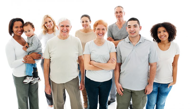 Group of Happy Multi-generation Family smiling and standing together.  Isolated on white background.